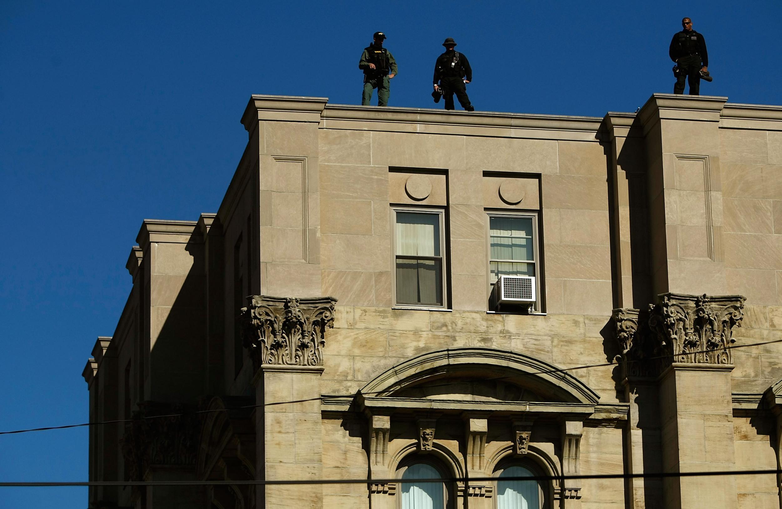 Police officers stand on top of the Jefferson County courthouse in Steubenville, Ohio in this photo from 2008