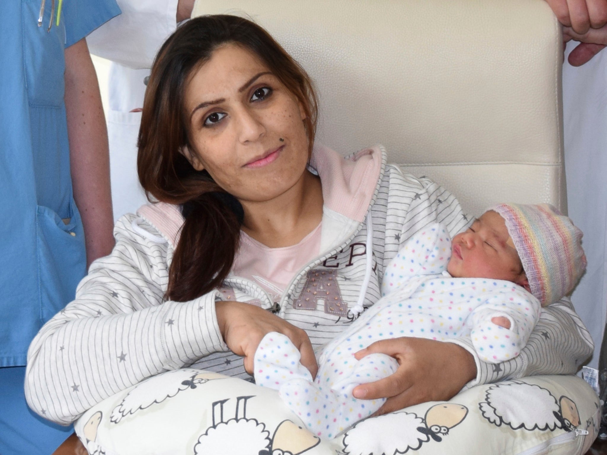 Asia Faray from Syria poses with her daughter Angela Merkel Muhammed at the St. Franziskus Hospital in Muenster