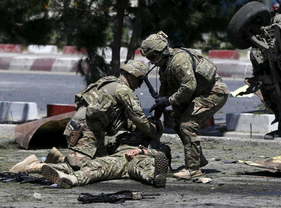 U.S. soldiers attend to a wounded soldier at the site of a blast in Kabul, Afghanistan in June of 2015.