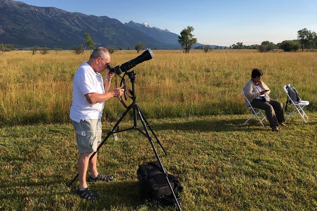 Tourists make the most of the clear skies to watch the solar eclipse near Jackson, Wyoming
