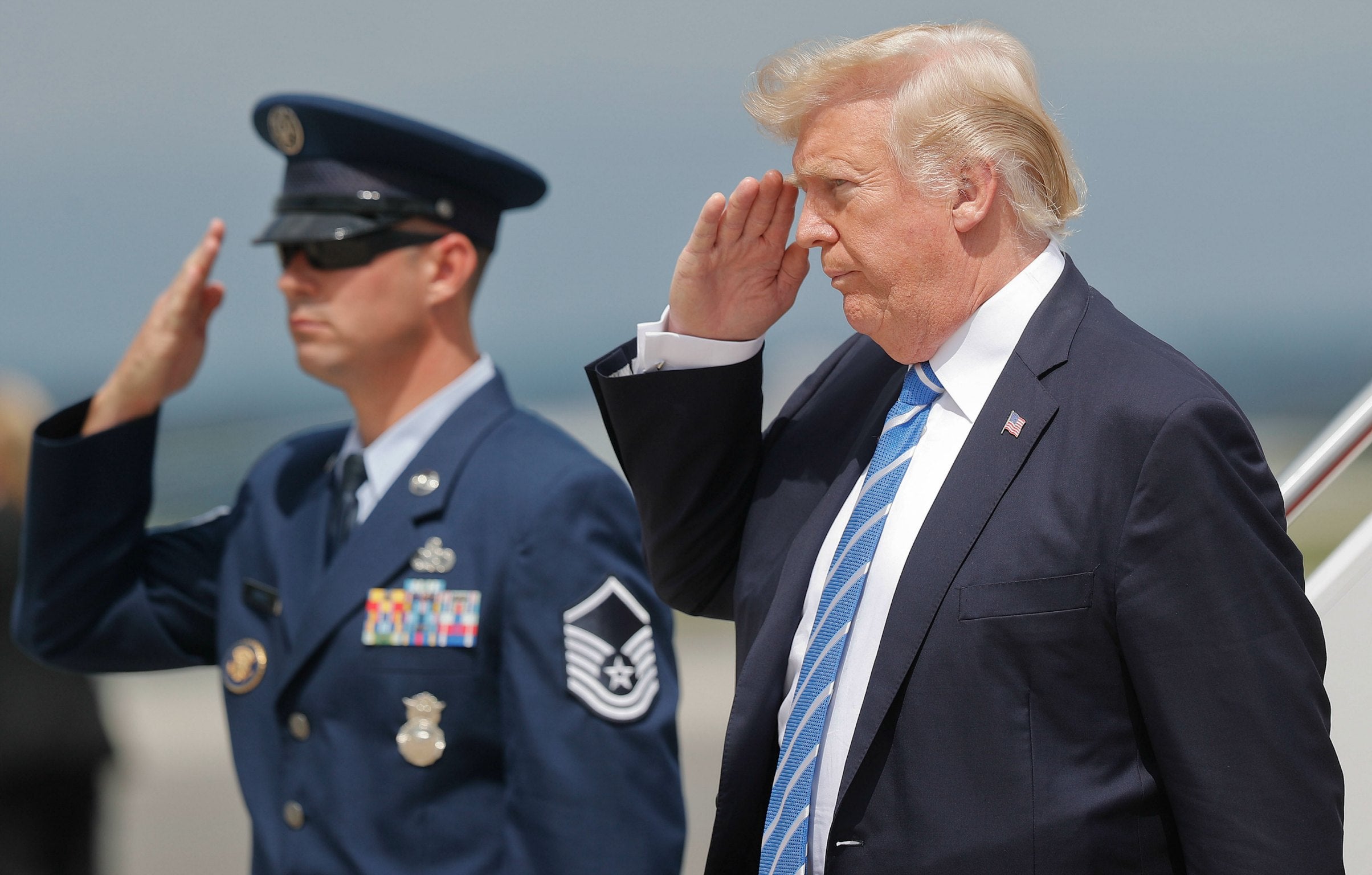 President Donald Trump returns a salute at Hagerstown Regional Airport in Hagerstown, Maryland, on Friday, Aug. 18, 2017.