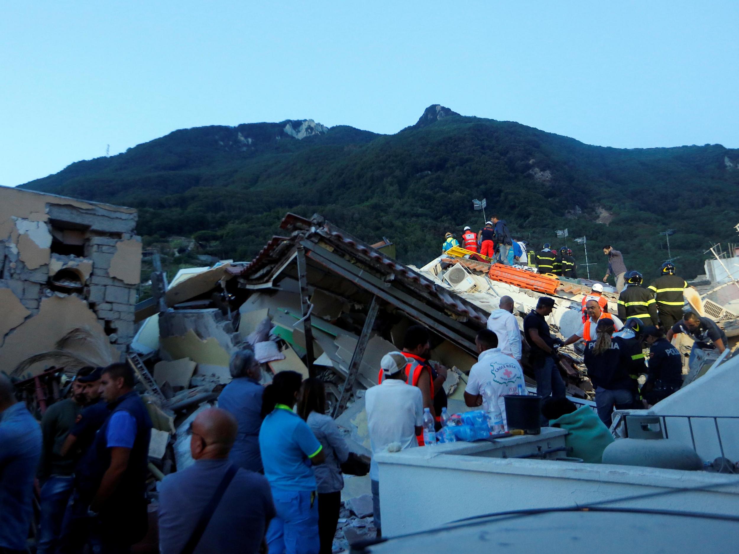 Rescue workers check a collapsed house after an earthquake hit the island of Ischia