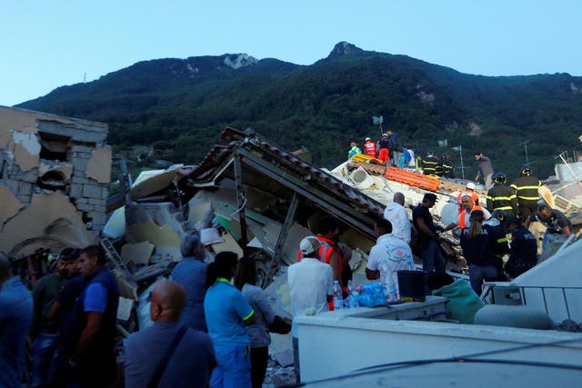 Rescue workers check a collapsed house after an earthquake hit the island of Ischia