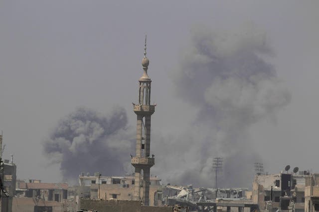Smoke rises after an air strike during fighting between members of the Syrian Democratic Forces and Islamic State militants in Raqqa, Syria