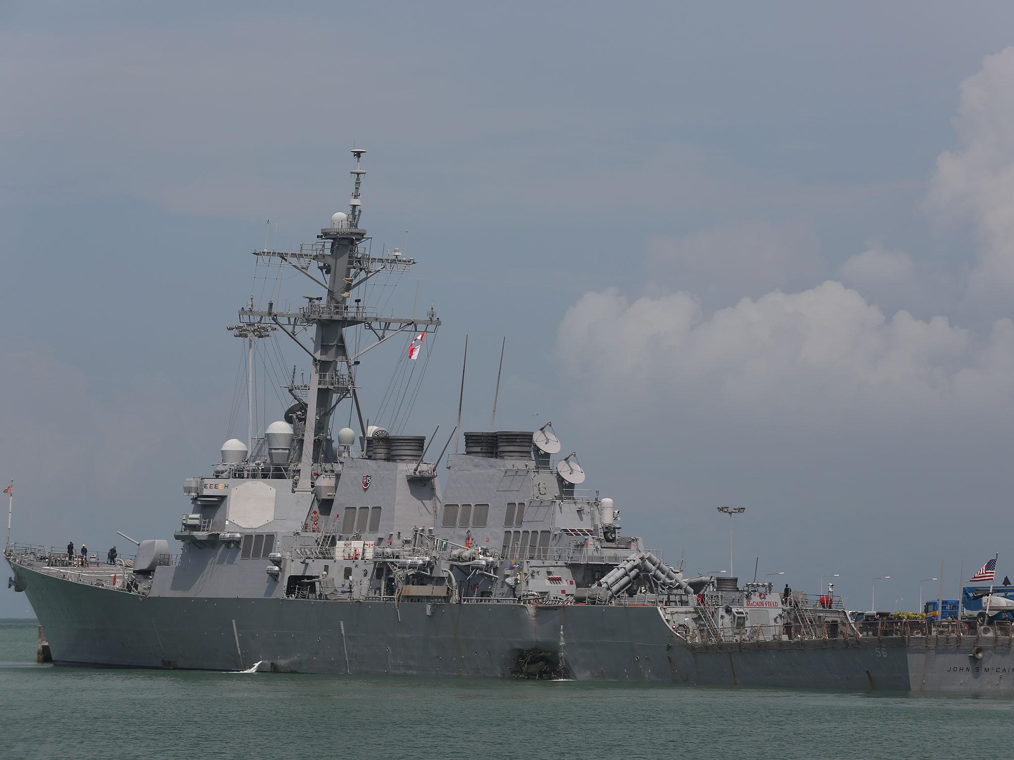 The guided-missile destroyer USS John S McCain moored pier side at Changi Naval Base, Singapore, following a collision with the merchant vessel Alnic MC while underway east of the Straits of Malacca and Singapore