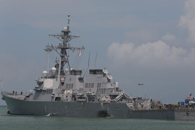 The guided-missile destroyer USS John S McCain moored pier side at Changi Naval Base, Singapore, following a collision with the merchant vessel Alnic MC while underway east of the Straits of Malacca and Singapore