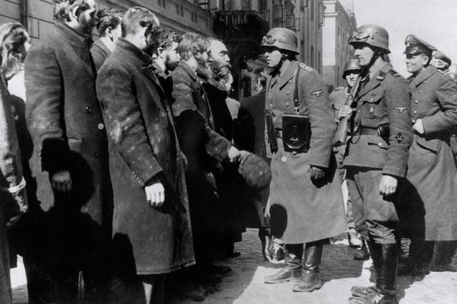 Nazi soldiers questioning Jews after the Warsaw Ghetto Uprising in 1943. Black Ribbon Day is commemorated to remember the victims of Nazism and Stalinism