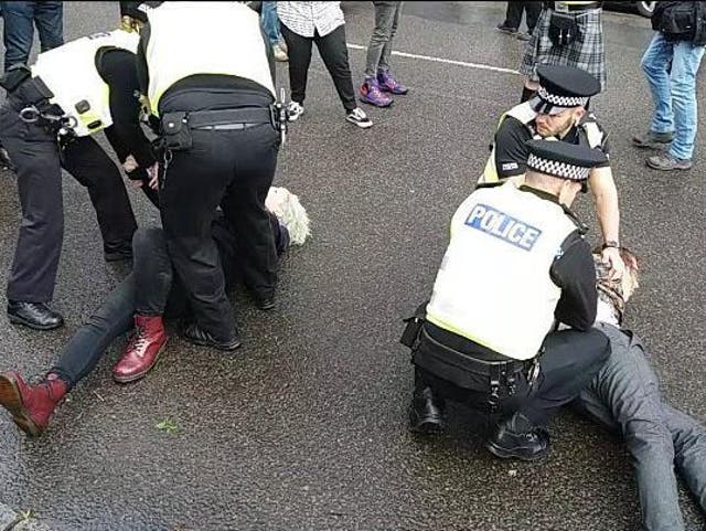 Police restrain protesters at Glasgow Pride