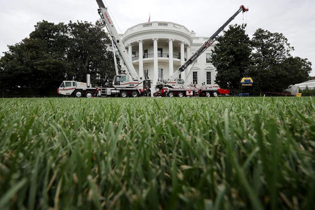 Construction cranes work to repair the South Portico steps as part of a large rennovation project at the White House