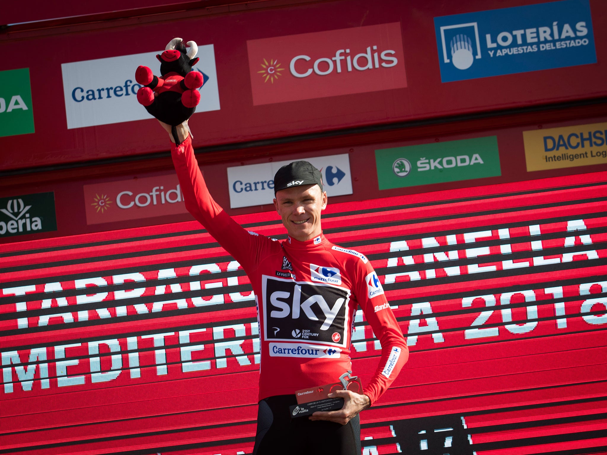 Chris Froome on the podium with the leader's red jersey