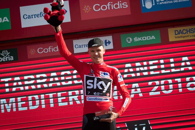 Chris Froome on the podium with the leader's red jersey