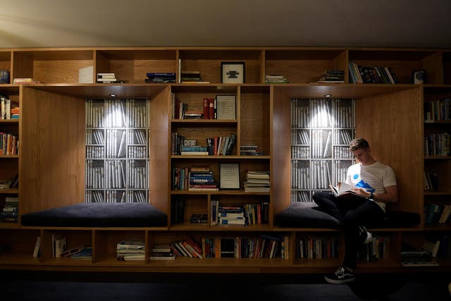 A resident relaxes in a communal library space 