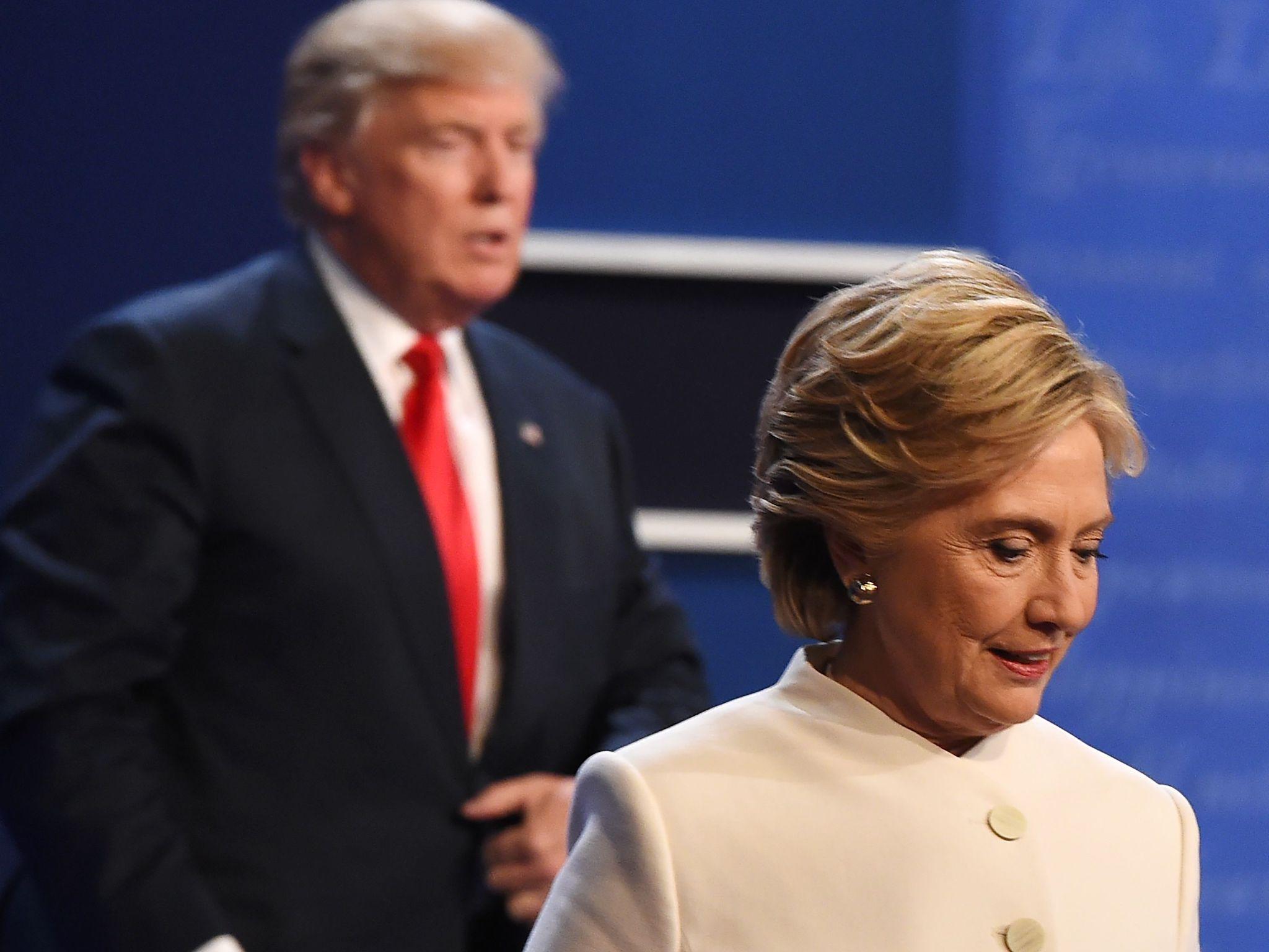 Democratic nominee Hillary Clinton and Republican nominee Donald Trump walk off the stage after the final presidential debate on 19 October