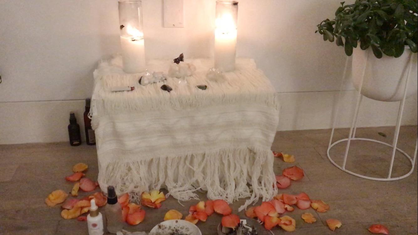 The altar at the front of the class was piled with candles and crystals