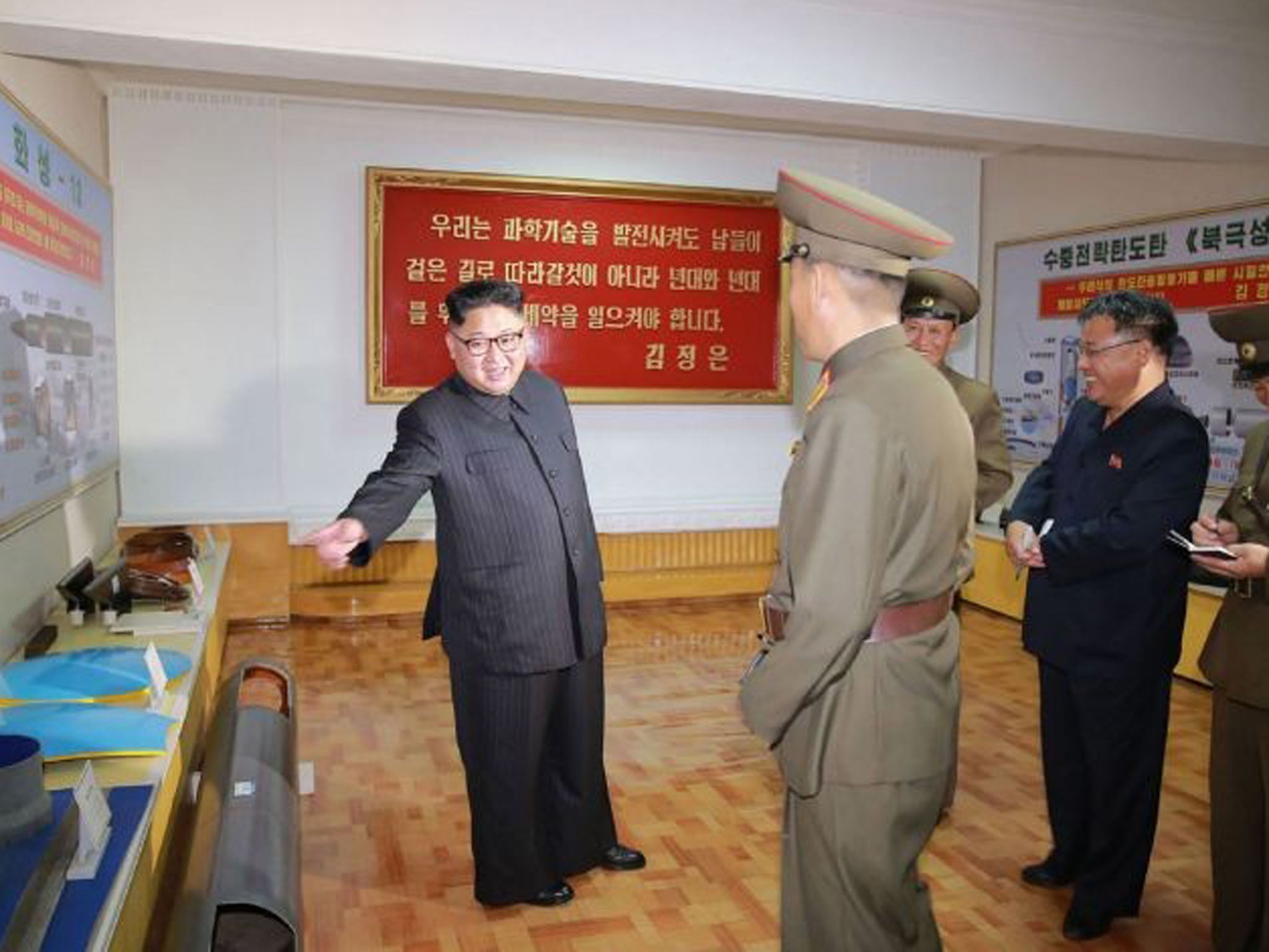 The undated picture shows Kim Jong-un surrounded by plans for new weapons