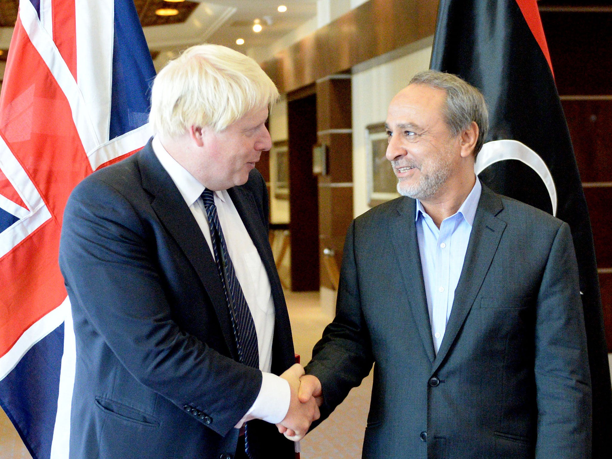 Boris Johnson shakes hands with chairman of the Libyan High Council of State, Abdulrahman Asswehly, in Tripoli on Wednesday
