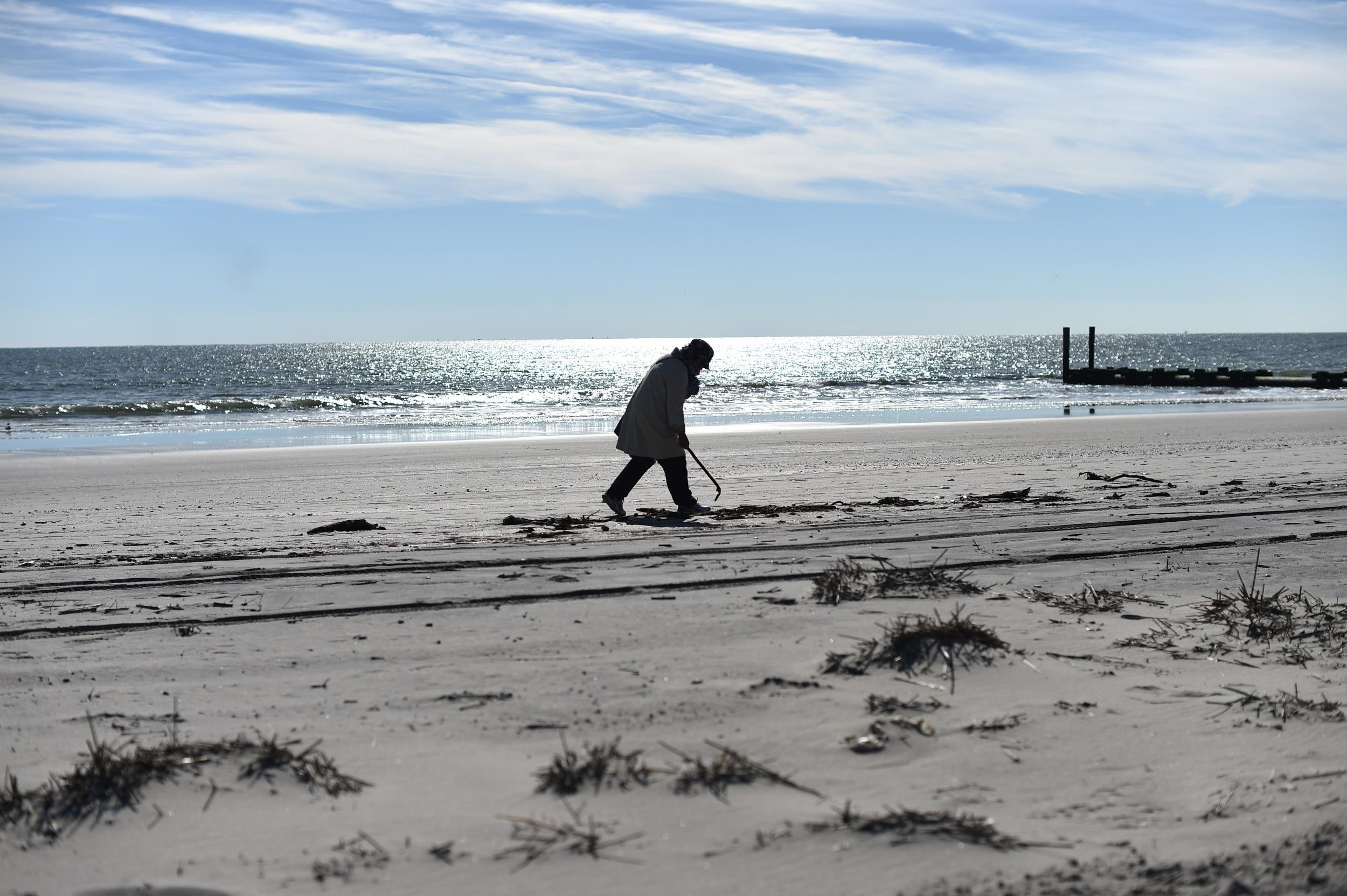 A woman walks along the beach in Ocean City, New Jersey