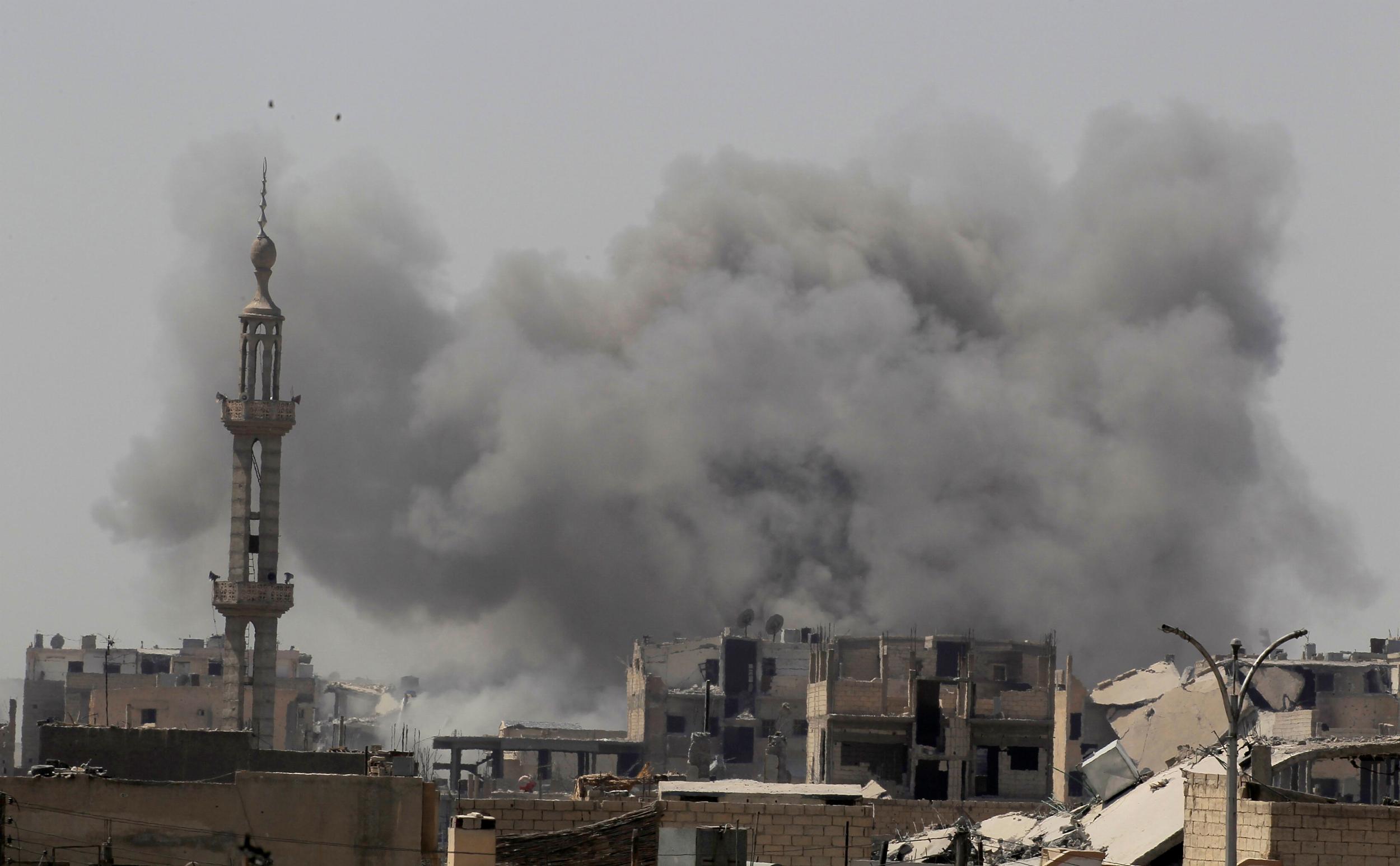 Smoke rises after an air strike during fighting between members of the US-backed Syrian Democratic Forces and Isis in Raqqa on 20 August 2017