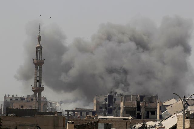 Smoke rises after an air strike during fighting between members of the US-backed Syrian Democratic Forces and Isis in Raqqa on 20 August 2017