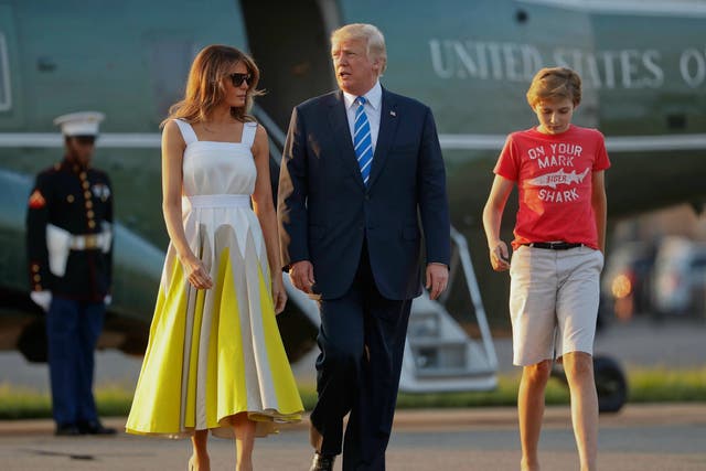 President Donald Trump, first lady Melania Trump and son Barron Trump walk across the tarmac in Morristown, N.J., on Aug. 20, 2017.