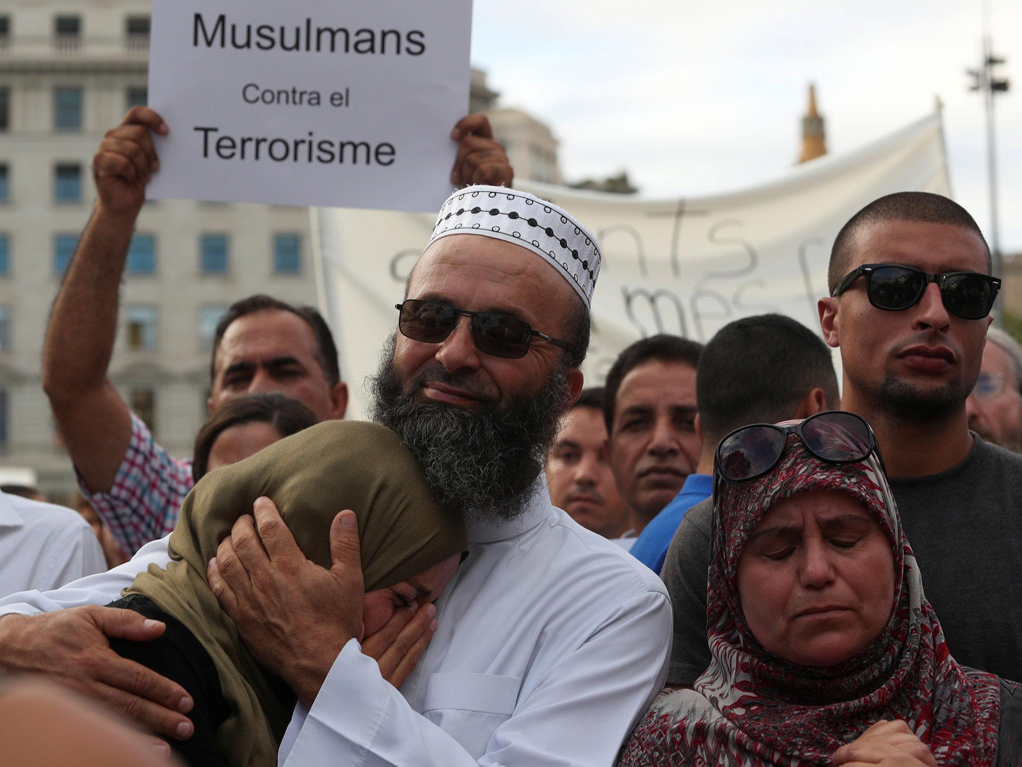 Muslims react as they gather at Plaza Catalunya to protest against terrorism in Barcelona, Spain