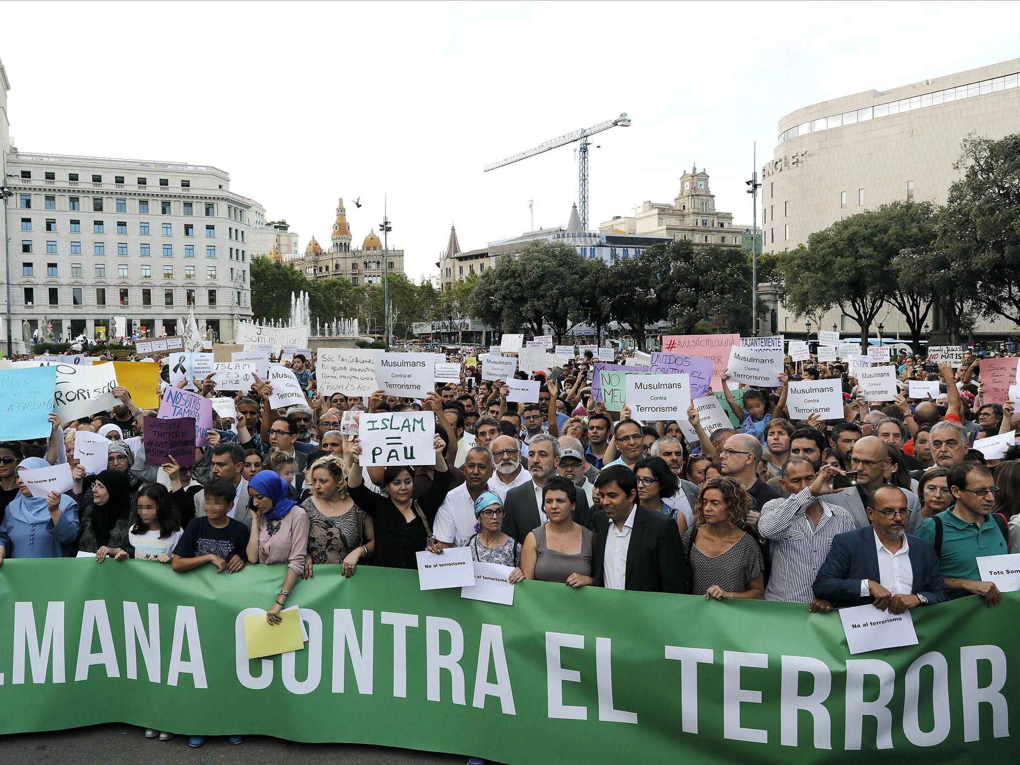People take part in a demonstration organised by several Muslim association of Catalonia which gathered the main religious denominations of the community to express their rejection of any type of terrorism after the attacks in Catalonia, in Barcelona