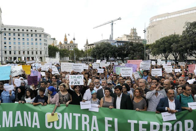 People take part in a demonstration organised by several Muslim association of Catalonia which gathered the main religious denominations of the community to express their rejection of any type of terrorism after the attacks in Catalonia, in Barcelona