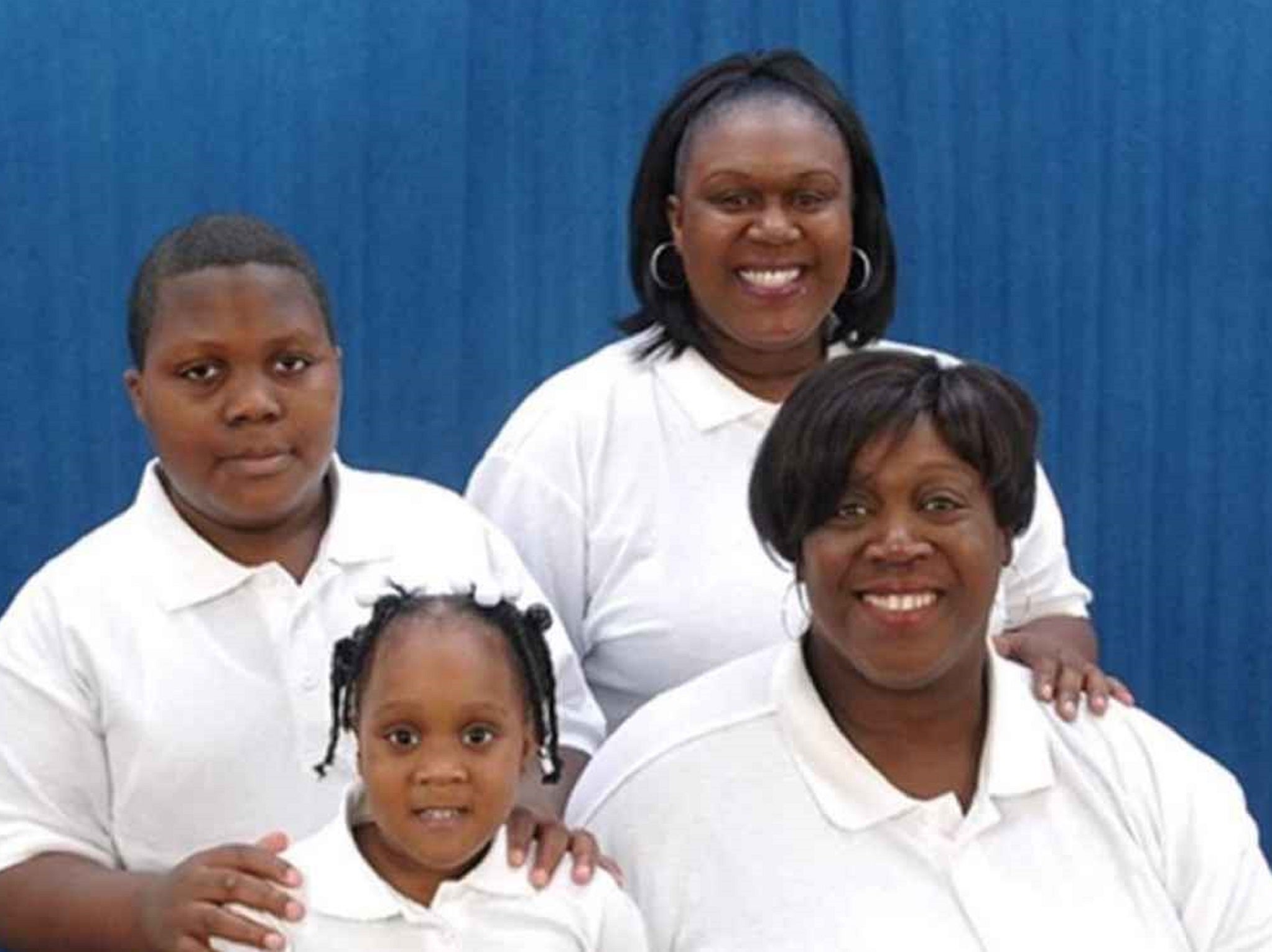 Alisha Coleman (bottom right), pictured with her two children and granddaughter, claims she was sacked by her employer after her period leaked on two occasions