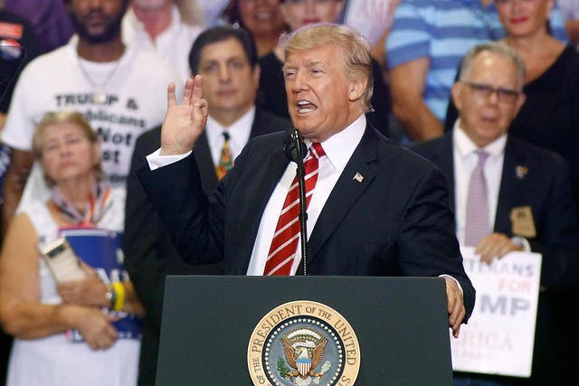 US President Donald Trump speaks to a crowd of supporters at the Phoenix Convention Center during a rally
