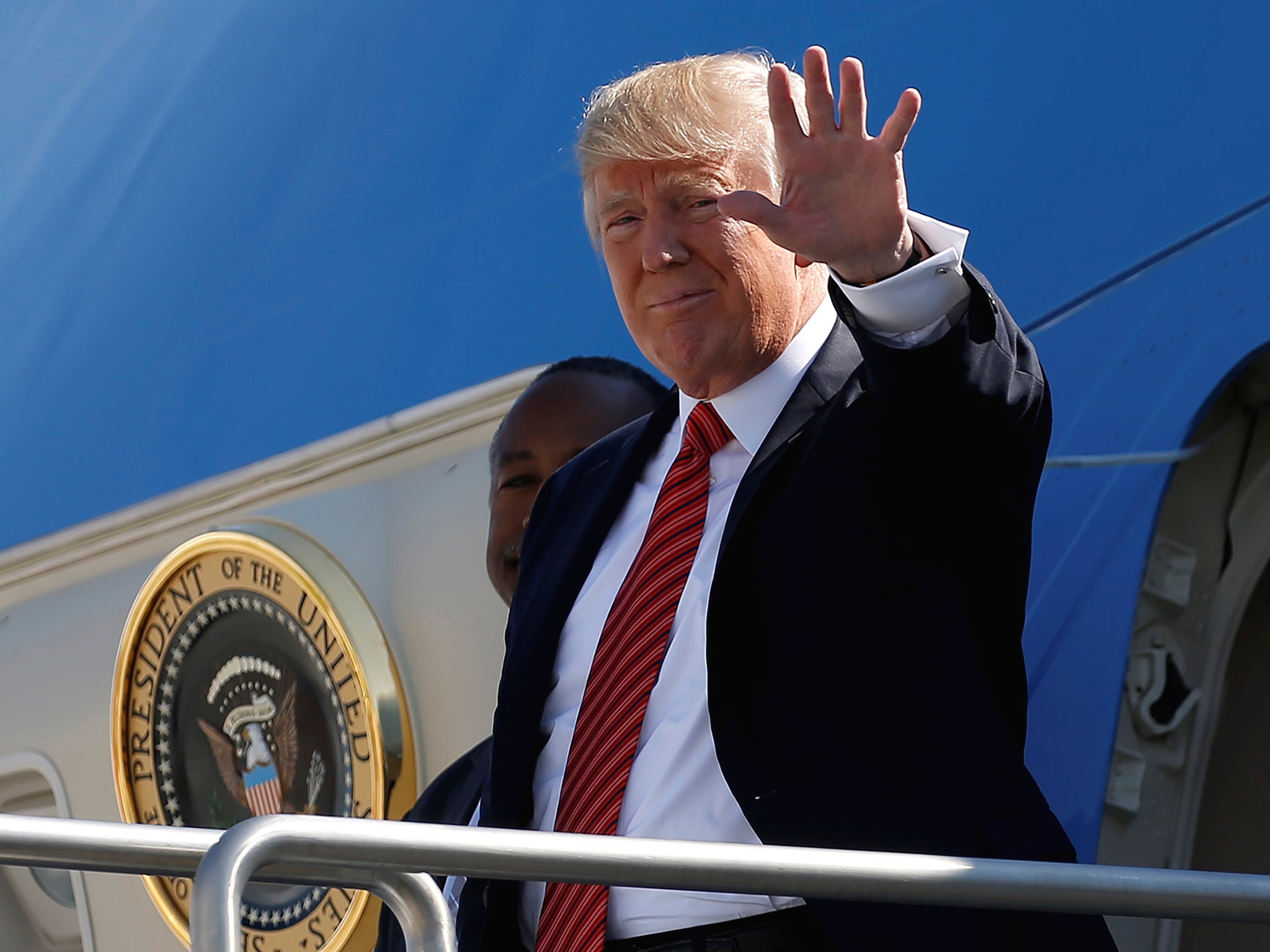President Donald Trump waves as he steps out from Air Force One in Reno, Nevada