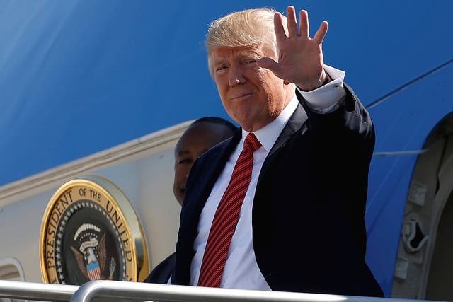 President Donald Trump waves as he steps out from Air Force One in Reno, Nevada