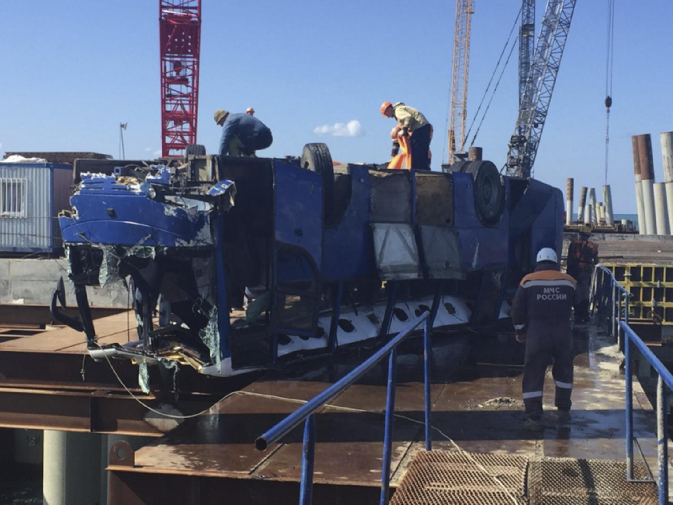 The damaged bus was hauled from the Black Sea after plunging off a pier while carrying construction workers near Volna