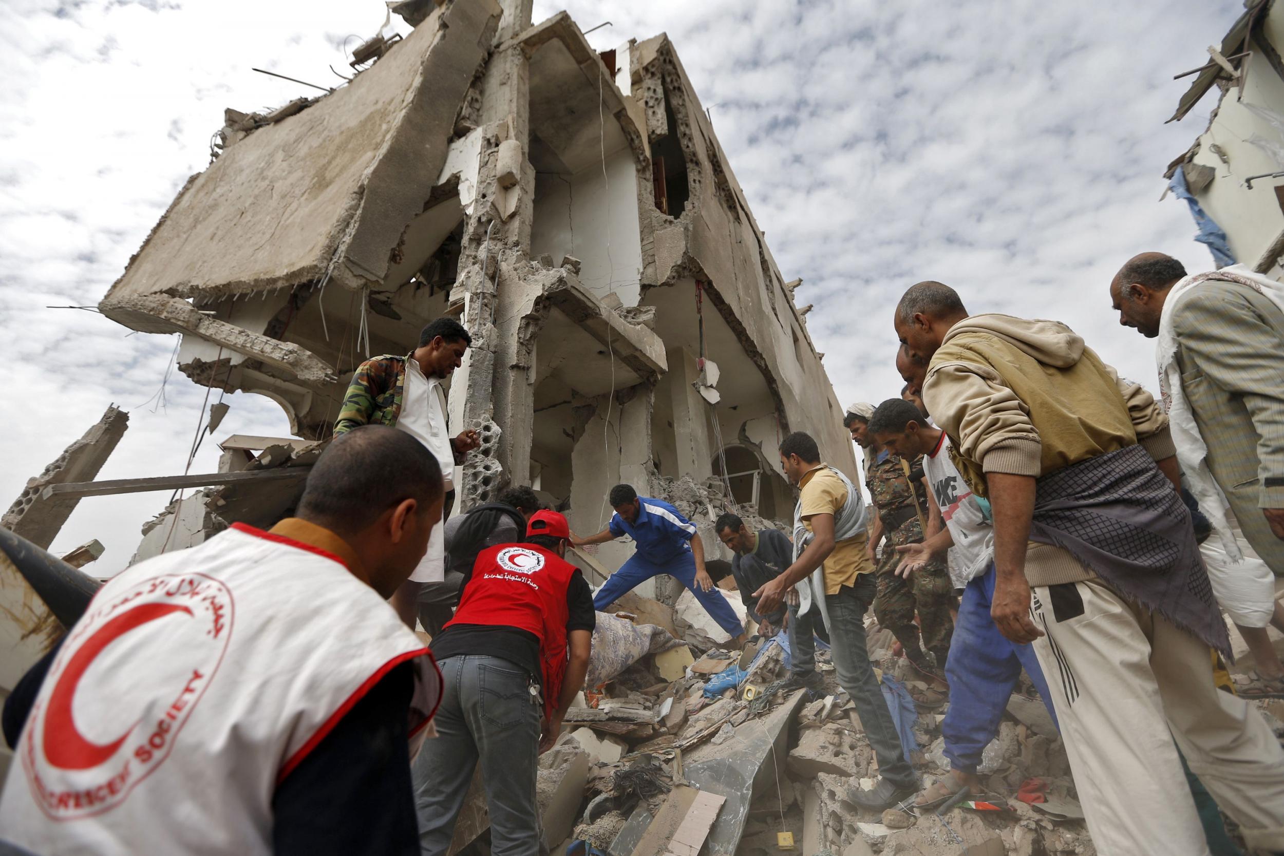 Rescuers search under the rubble of a house destroyed in an air strike in the residential Faj Attan district of the the Yemeni capital Sanaa on 26 August 2017