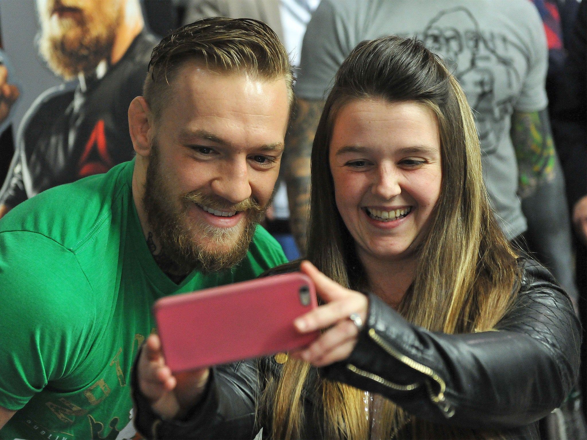 A smiling, very different Conor McGregor poses with fans at JD Sports in Dublin