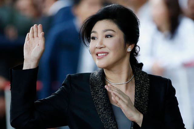  Yingluck Shinawatra waves to supporters as she arrives to deliver closing statements in her trial on 1 August - but has apparently fled before hearing the verdict
