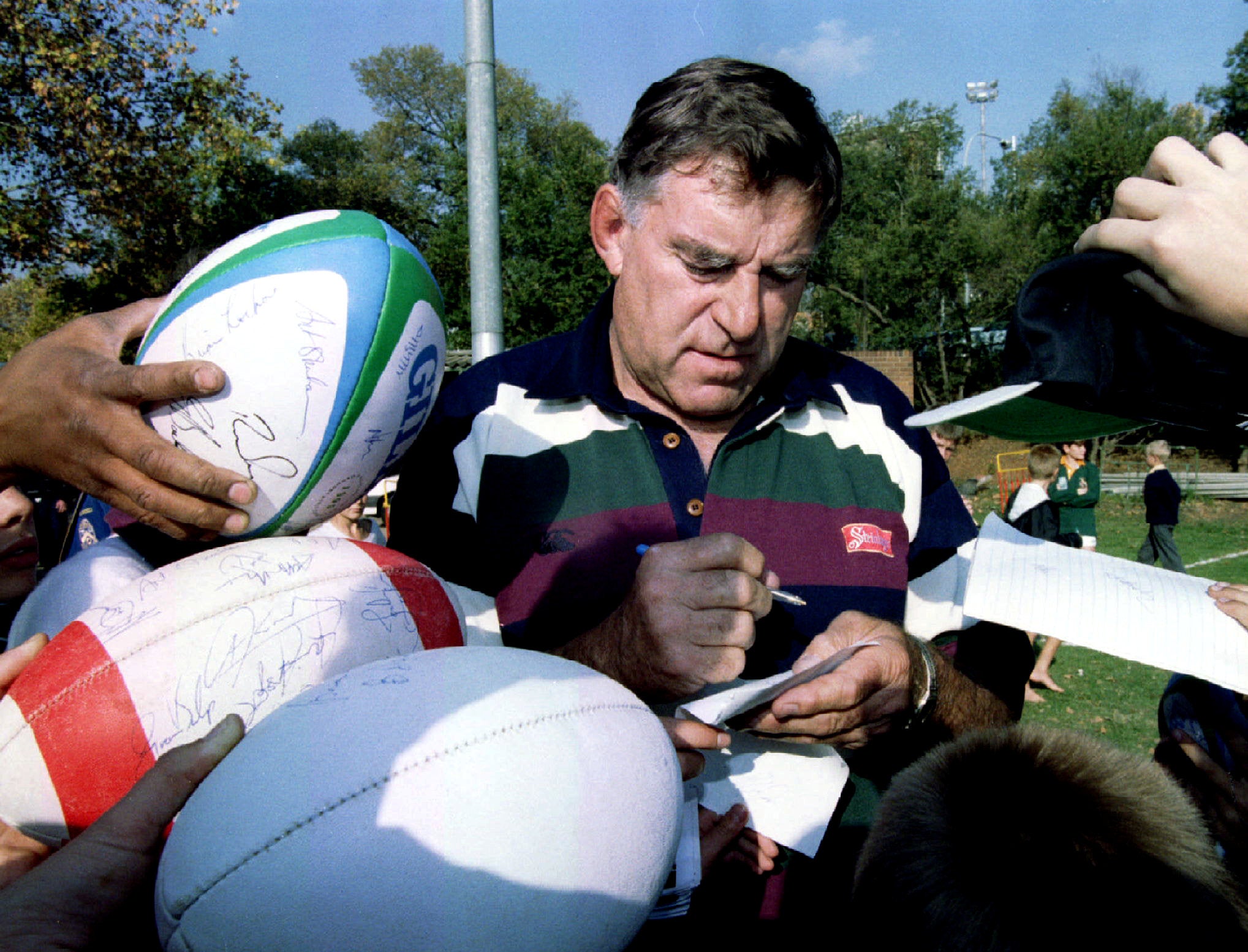 Meads signing autographs for Johannesburg schoolchildren prior to the 1995 World Cup, where he managed New Zealand (Reuters)