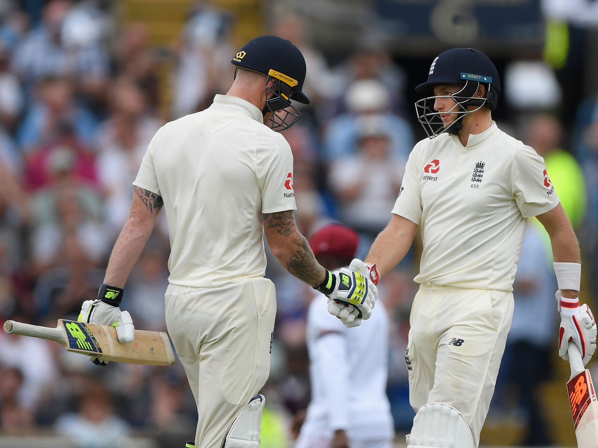 Joe Root is congratulated by Ben Stokes after reaching his 50