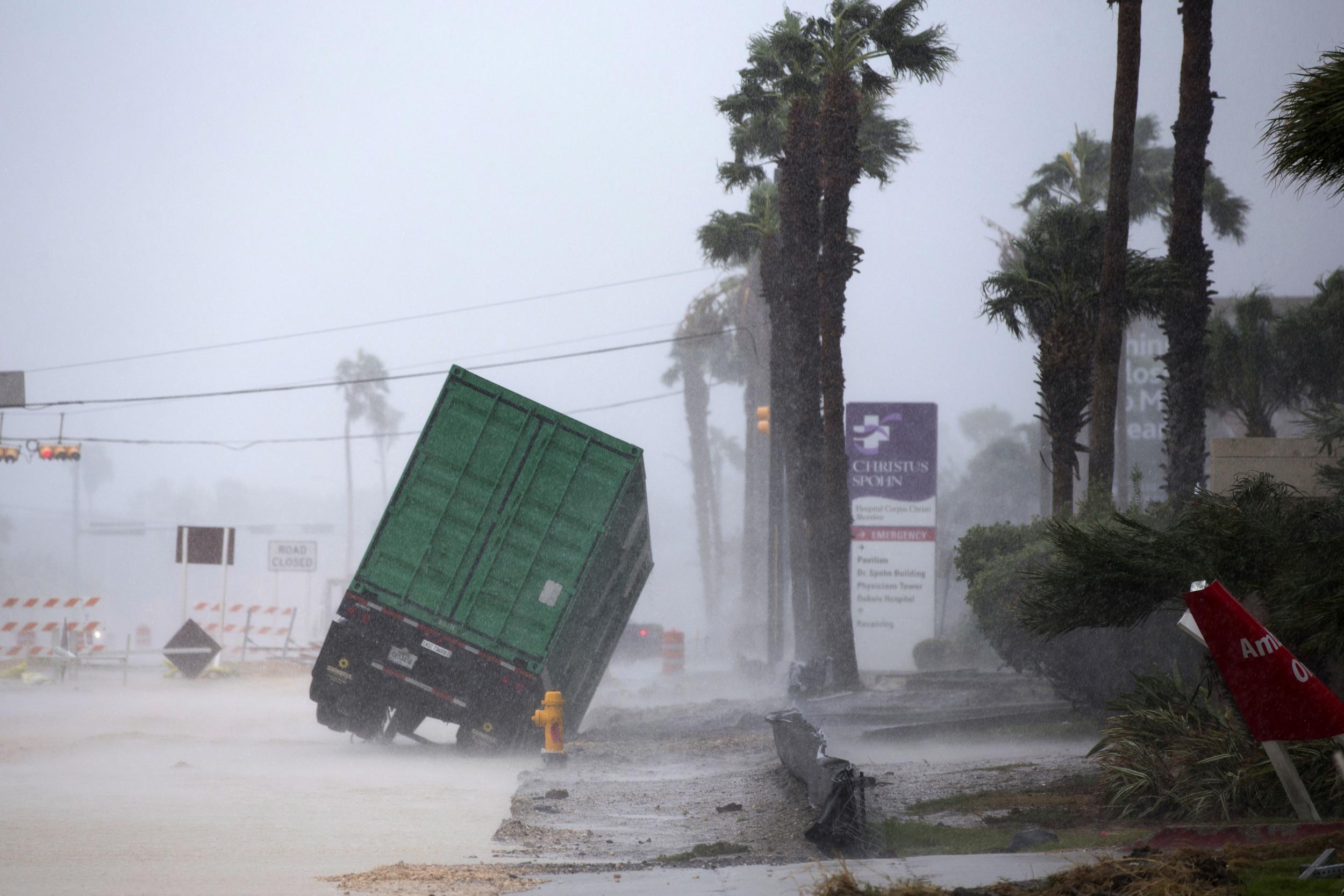 A power generator tips in the wind in front ofChristusSpohnHospital in Corpus Christi, Texas, as Hurricane Harvey hits (CourtneySacco/Corpus Christi Caller-Times via AP)