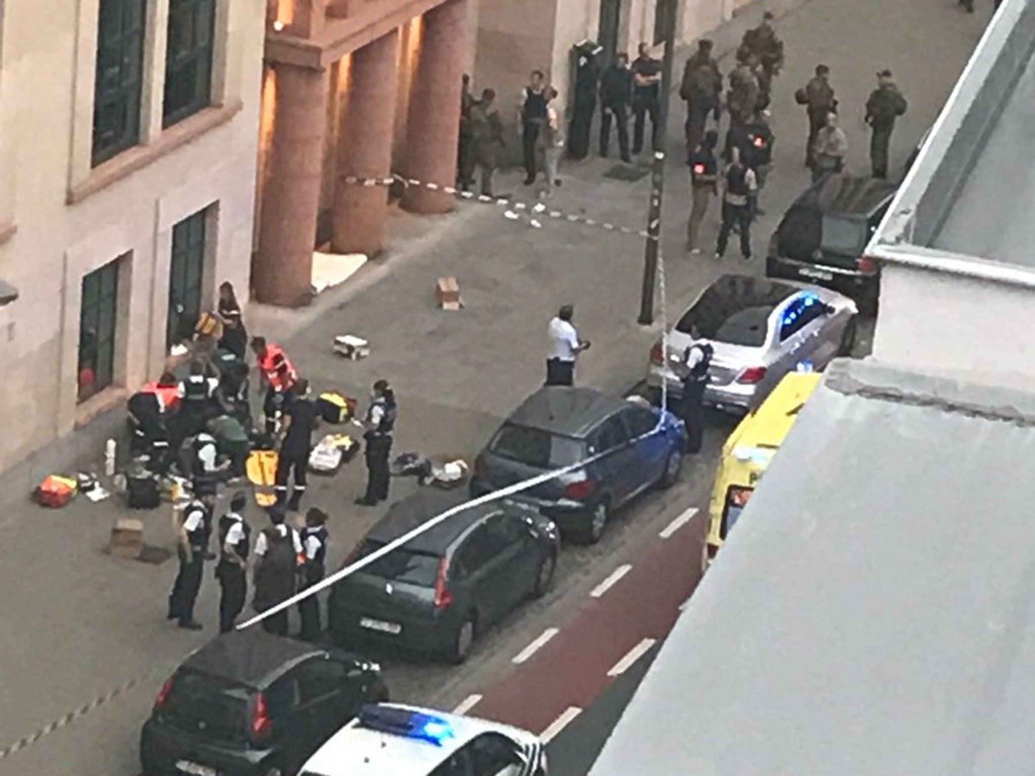 Belgian police and soldiers at the scene where a man attacked soldiers with a knife in Brussels on 25 August