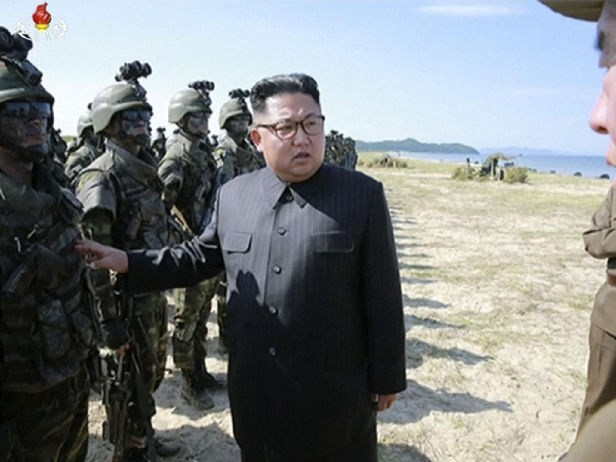 North Korean leader Kim Jong-un inspecting soldiers shortly before his country launched three missiles into the sea