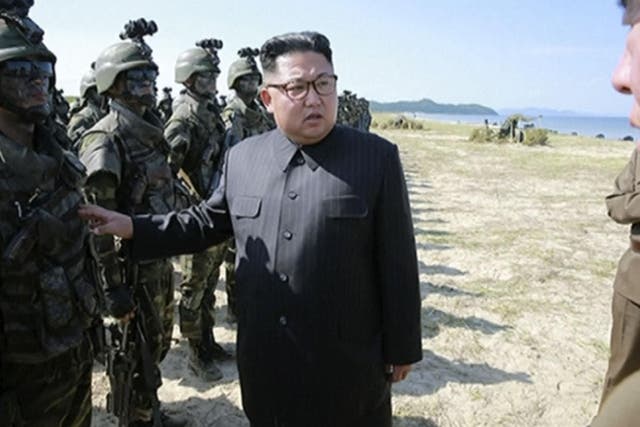 North Korean leader Kim Jong-un inspecting soldiers shortly before his country launched three missiles into the sea