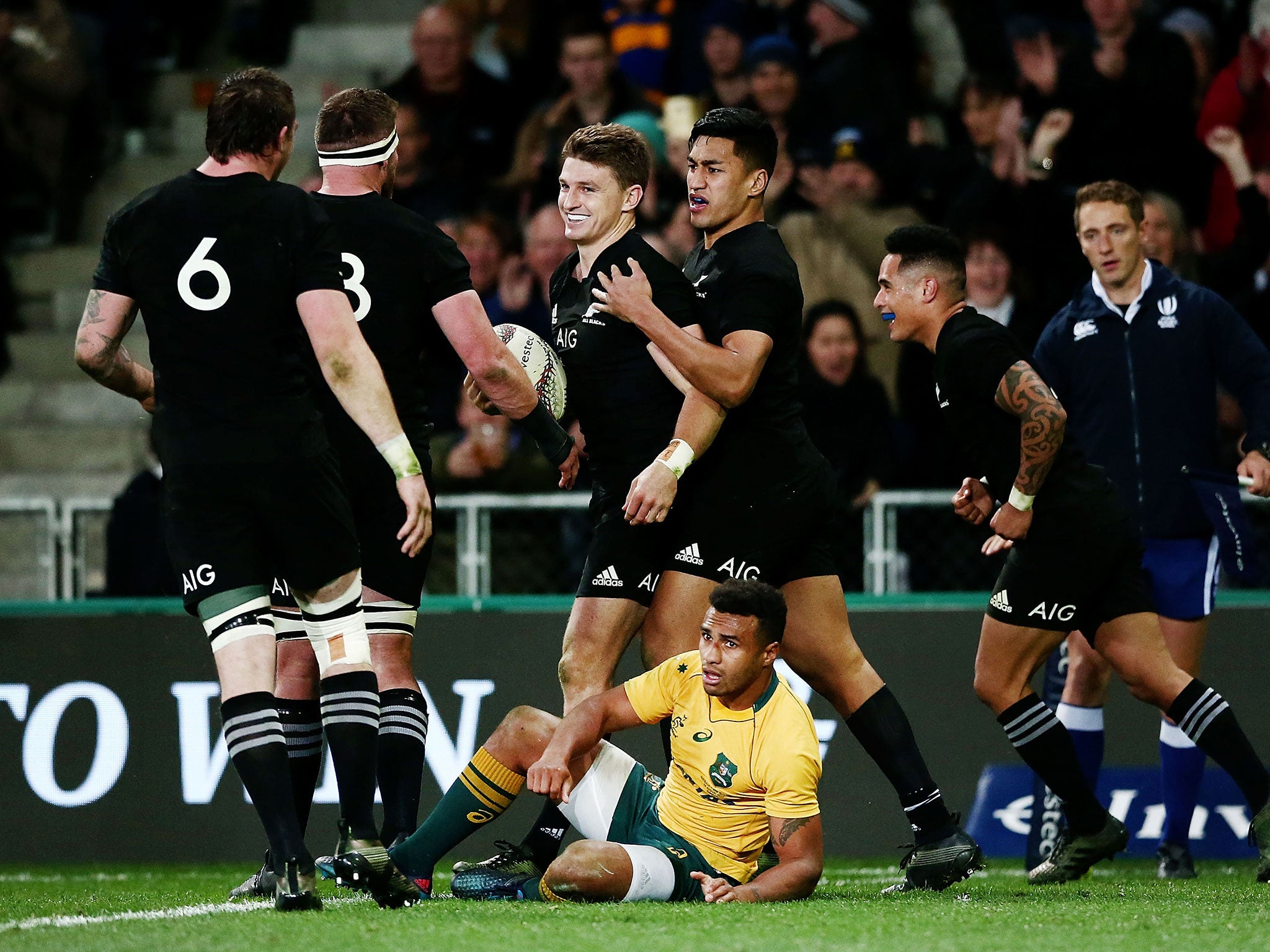 Beauden Barrett celebrates with his New Zealand teammates after scoring a try