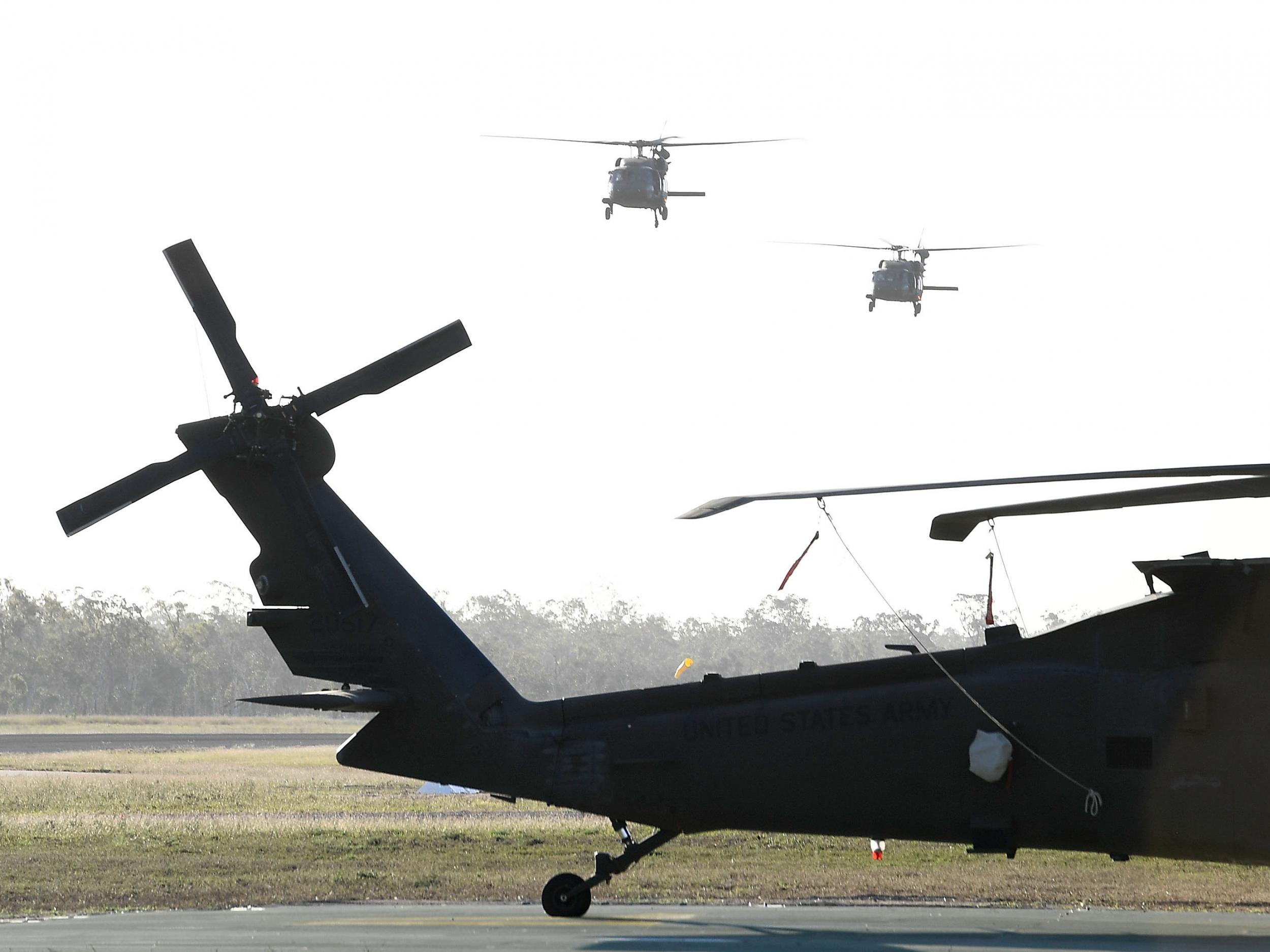 Two US army Black Hawk helicopters are seen landing
