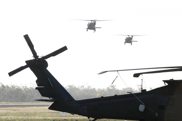 Two US army Black Hawk helicopters are seen landing