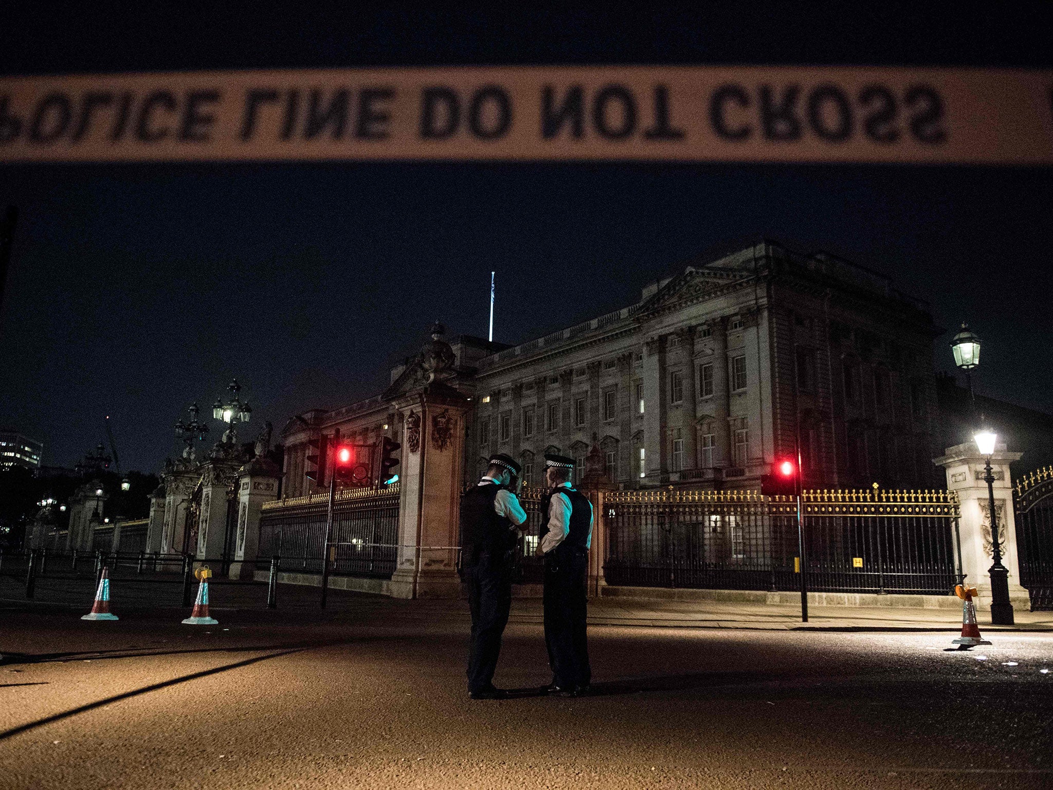 Police officers stand guard at a police cordon next to Buckingham Palace following an incident on 25 August
