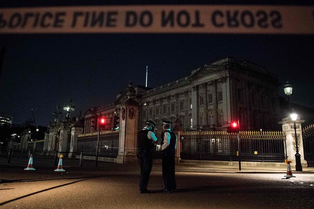 Police officers stand guard at a police cordon next to Buckingham Palace following an incident  on 25 August