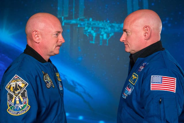 Astronaut Scott Kelly (R) stands alongside his identical twin brother Mark on January 19, 2015.