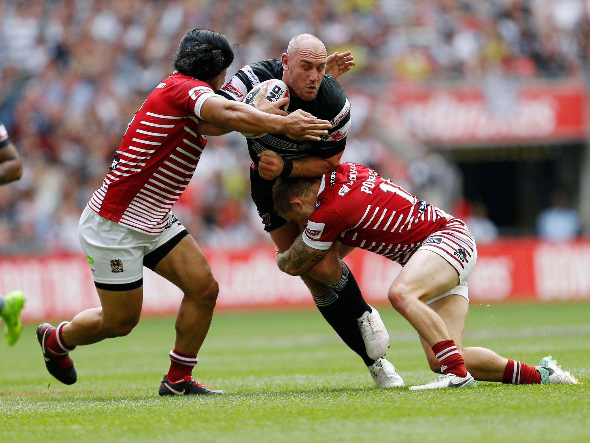 Gareth Ellis is tackled by Sam Powell and Taulima Tautai