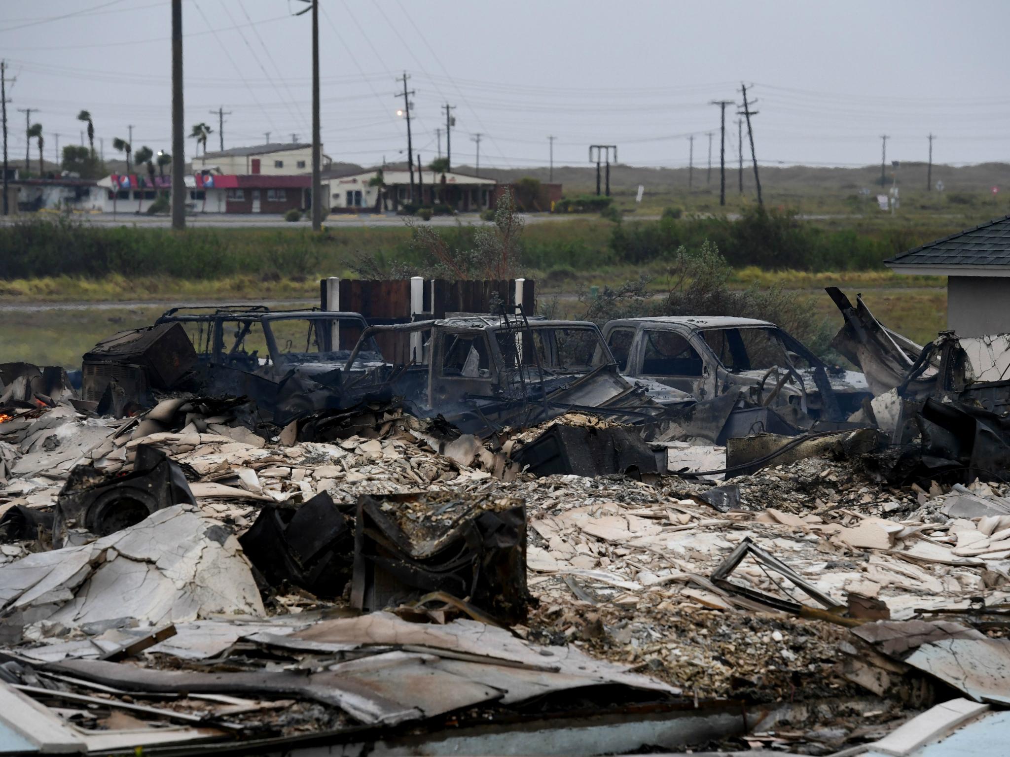 A burnt out house and cars that caught fire are seen after Hurricane Harvey hit Corpus Christi, Texas on 26 August 2017