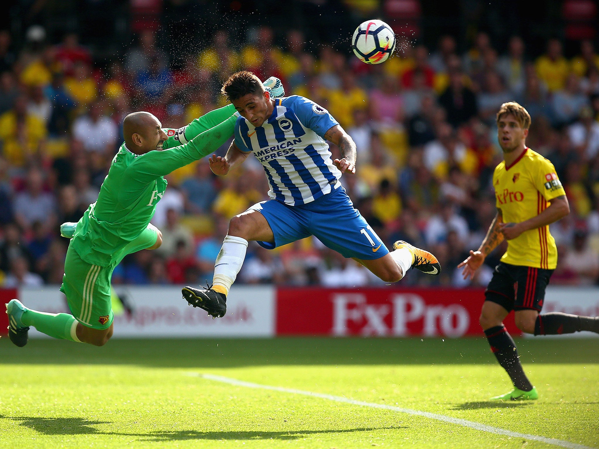 Heurelho Gomes punches the ball away under pressure from Anthony Knockaert